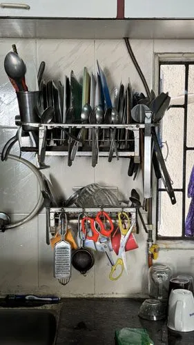 The Appetite of a City — kitchen in a Bandra apartment, steel bhagonas stacked. Photograph by Rini Singhi.