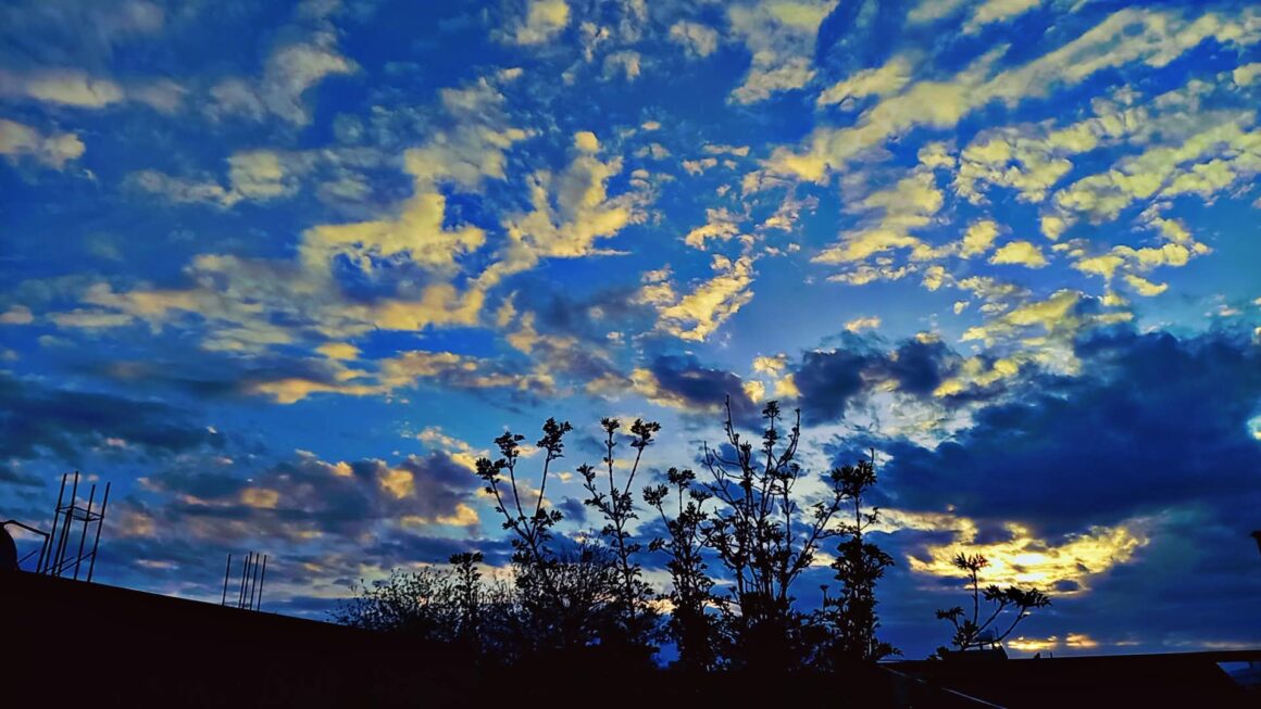 Blue Sky with White Clouds — photograph by Qadira Alizada. Taken after a spring rain in Afghanistan.